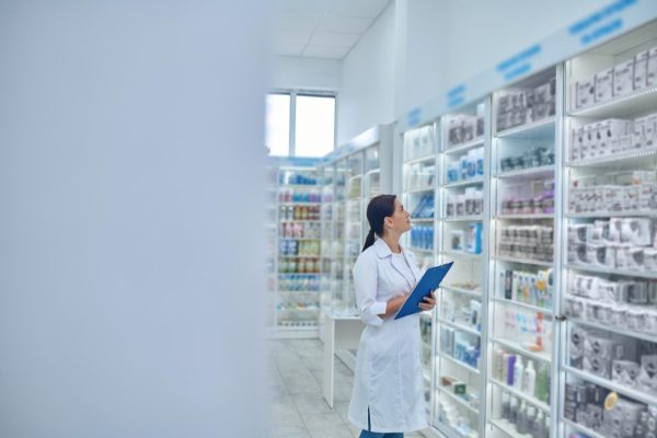 pharmacist-checking-medicines-drugstore